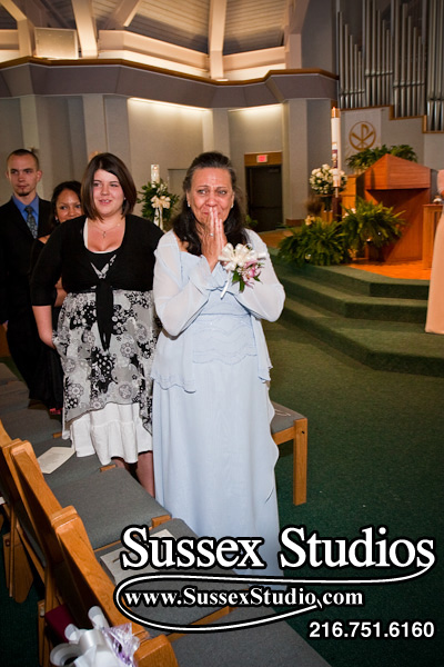 Jennifer's Mom watching Jennifer walk down aisle